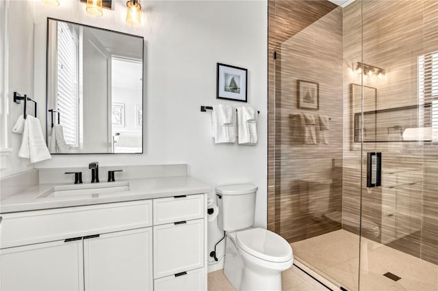 bathroom featuring vanity, toilet, and walk in shower