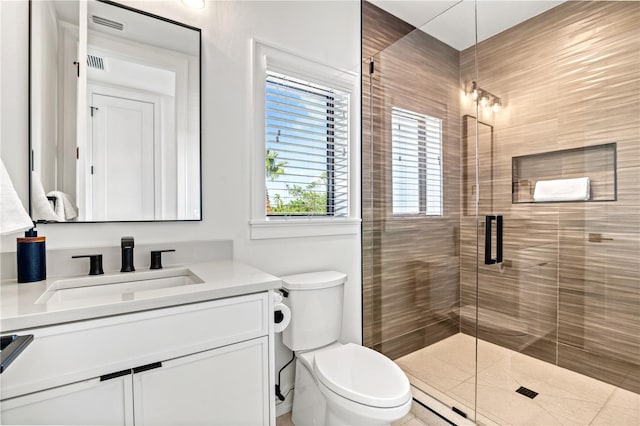 bathroom with walk in shower, vanity, and toilet