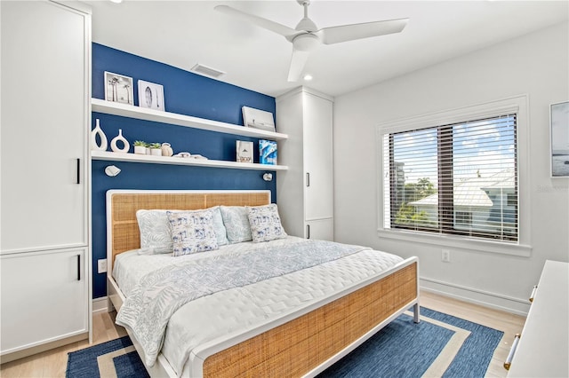 bedroom with light wood-type flooring and ceiling fan