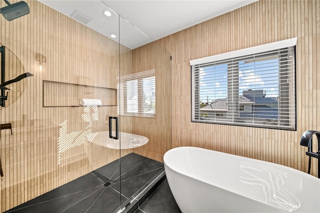 bathroom featuring tile patterned floors and independent shower and bath