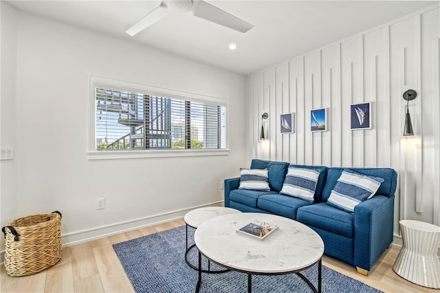 living room featuring light hardwood / wood-style flooring and ceiling fan