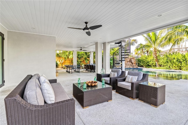 view of patio with an outdoor living space and ceiling fan