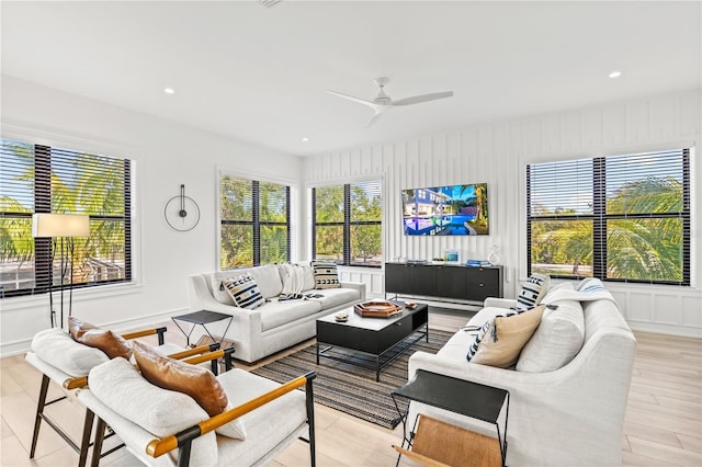 living room with ceiling fan and light wood-type flooring