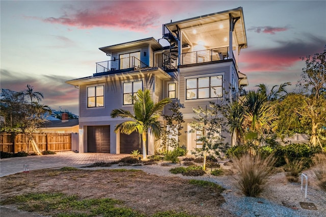 contemporary home featuring a garage and a balcony