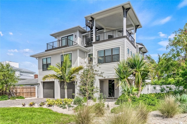 view of front of home with a balcony and a garage