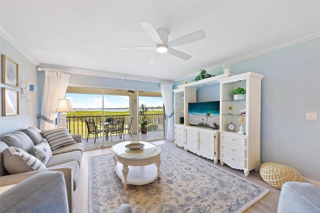 living room featuring hardwood / wood-style floors, ceiling fan, and crown molding