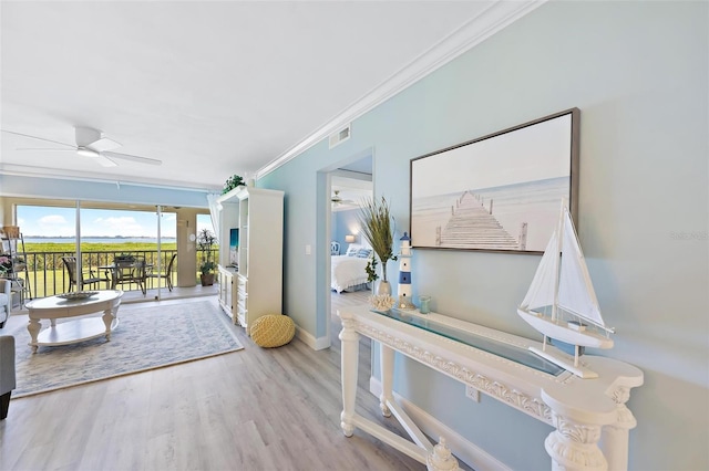 interior space with light hardwood / wood-style floors, ceiling fan, and ornamental molding