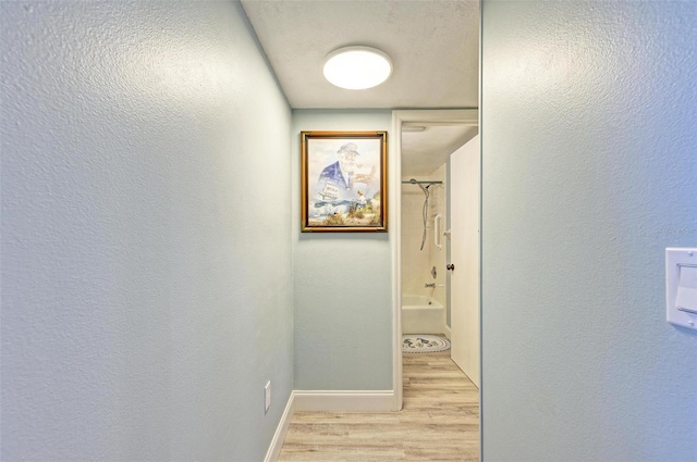 hallway with light hardwood / wood-style floors