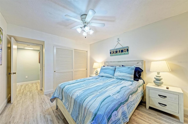 bedroom with light wood-type flooring, a closet, and ceiling fan