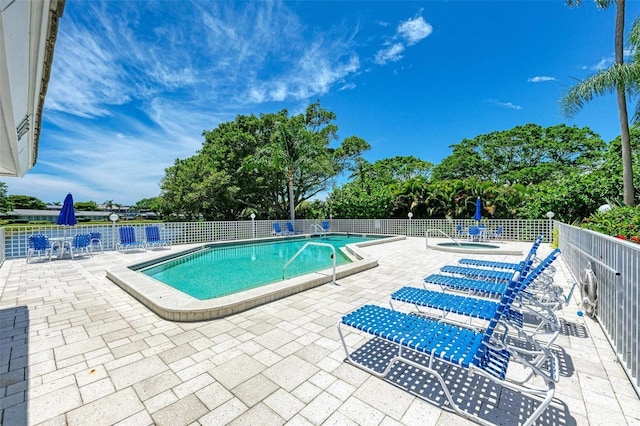 view of pool with a community hot tub and a patio area