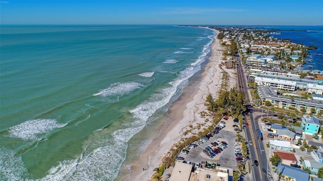 birds eye view of property with a water view and a beach view