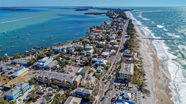 bird's eye view featuring a water view and a beach view