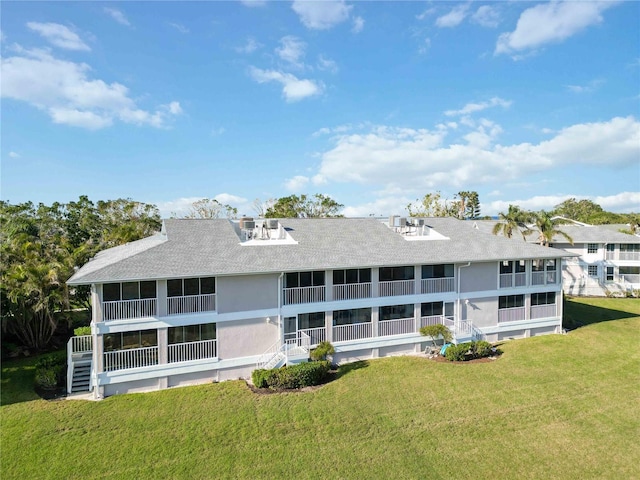 rear view of property with a yard