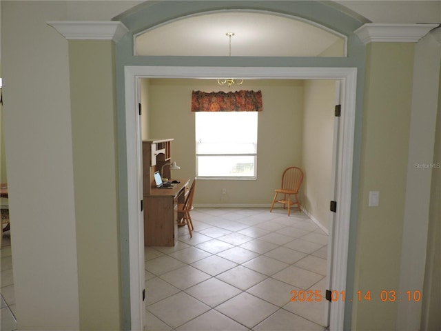 hall featuring light tile patterned flooring and crown molding