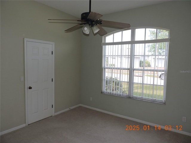 spare room featuring ceiling fan, vaulted ceiling, and carpet flooring