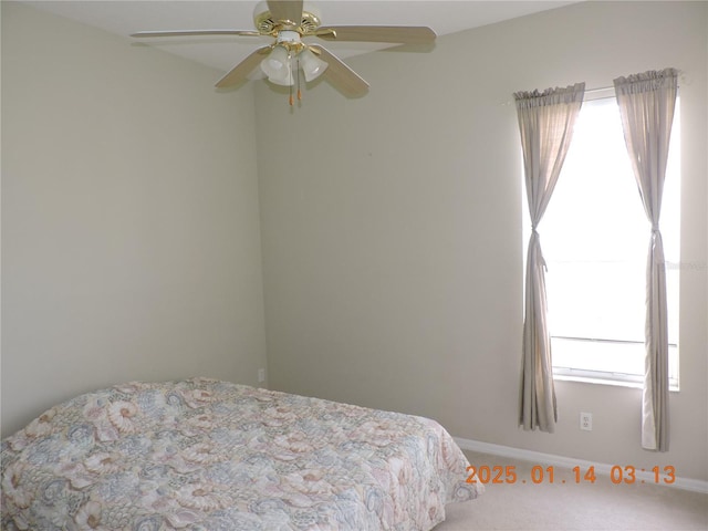 bedroom with ceiling fan and carpet