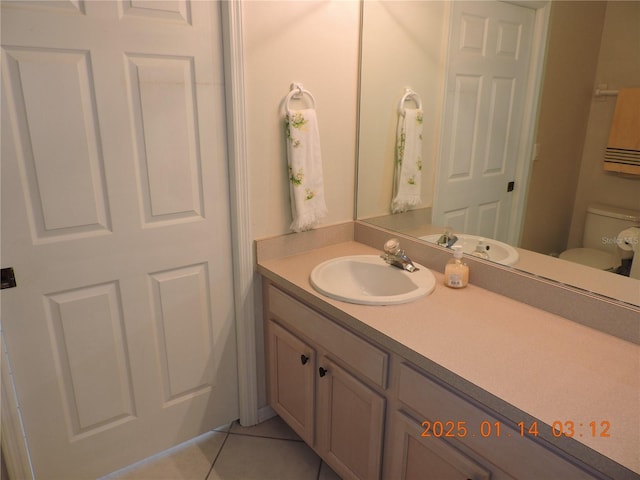 bathroom featuring toilet, vanity, and tile patterned floors