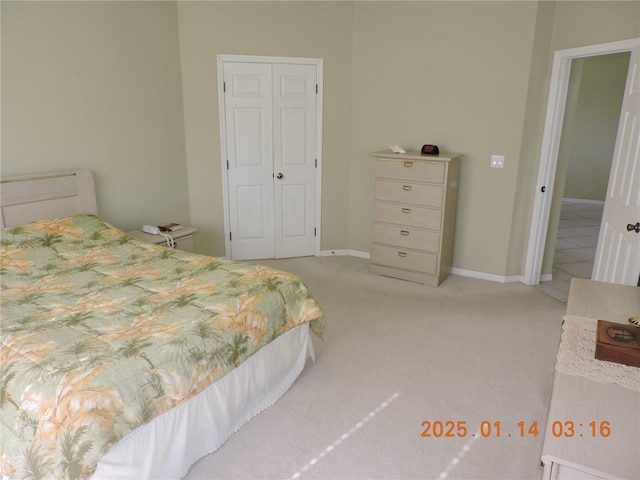 bedroom with a closet and light carpet