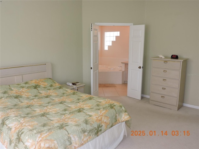 bedroom with light tile patterned floors and connected bathroom