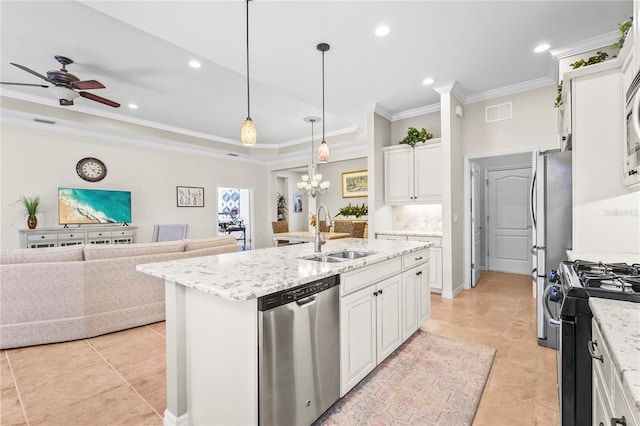 kitchen featuring appliances with stainless steel finishes, sink, white cabinetry, and an island with sink