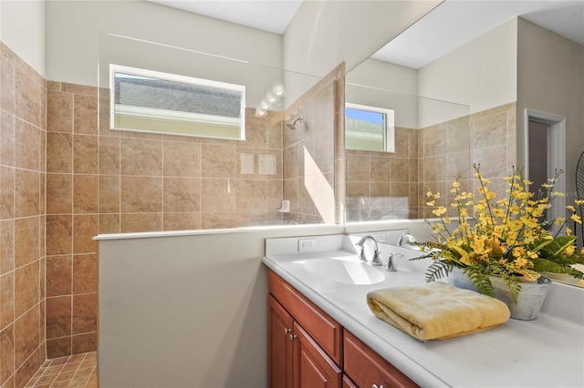 bathroom with vanity and a tile shower