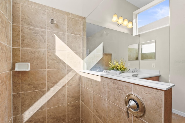 bathroom with vanity and a tile shower