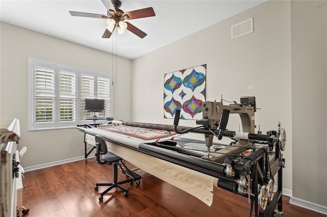 exercise room featuring wood-type flooring and ceiling fan