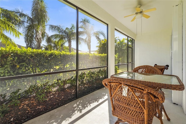 sunroom featuring ceiling fan