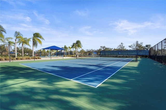 view of tennis court with a gazebo and basketball hoop