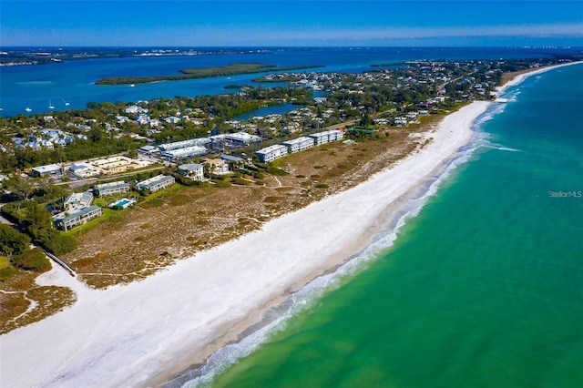 birds eye view of property with a beach view and a water view