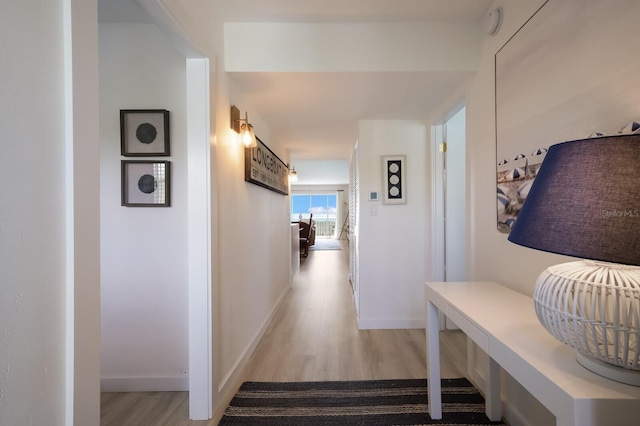 hallway with light hardwood / wood-style flooring