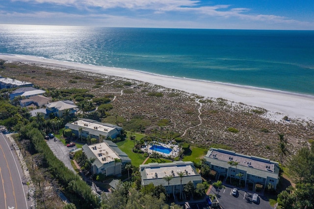 bird's eye view with a water view and a beach view