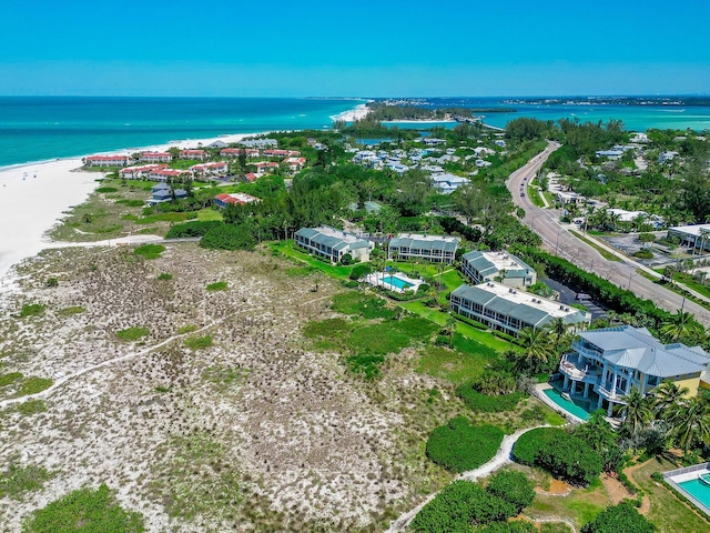 aerial view with a water view and a beach view