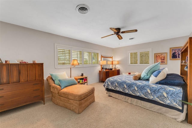 bedroom with light carpet and ceiling fan