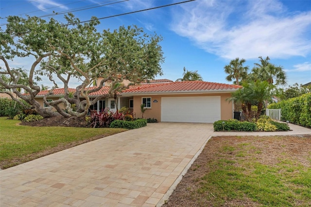 view of front of property with a garage and a front lawn