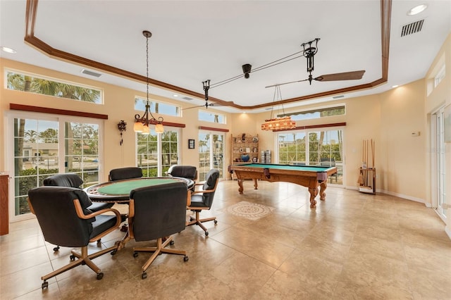 playroom with crown molding, a tray ceiling, and a wealth of natural light