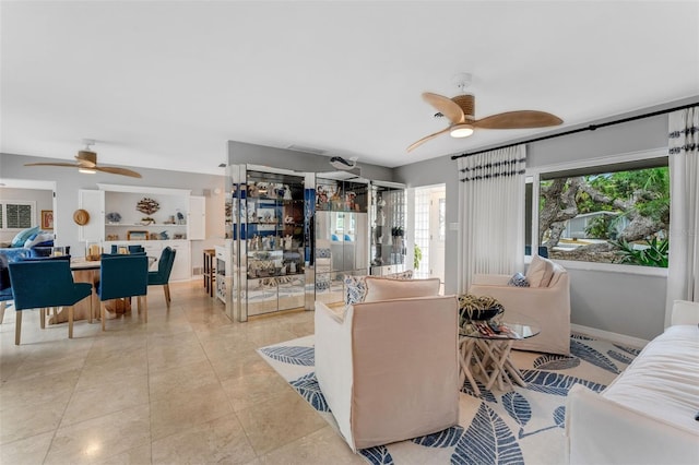 tiled living room with ceiling fan