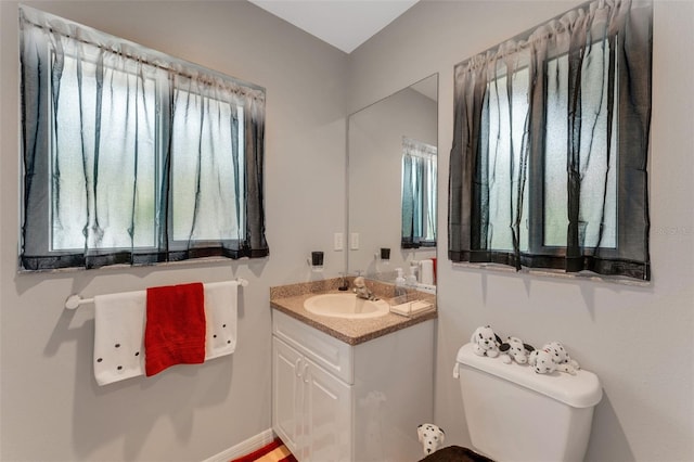 bathroom featuring vanity and toilet