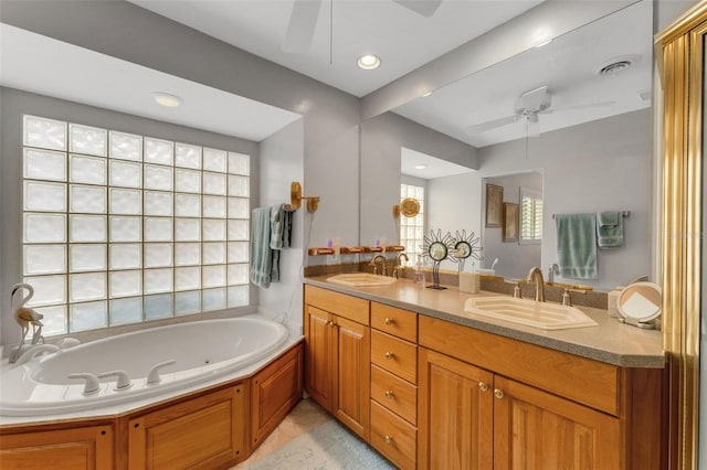 bathroom with vanity, a bathing tub, and ceiling fan