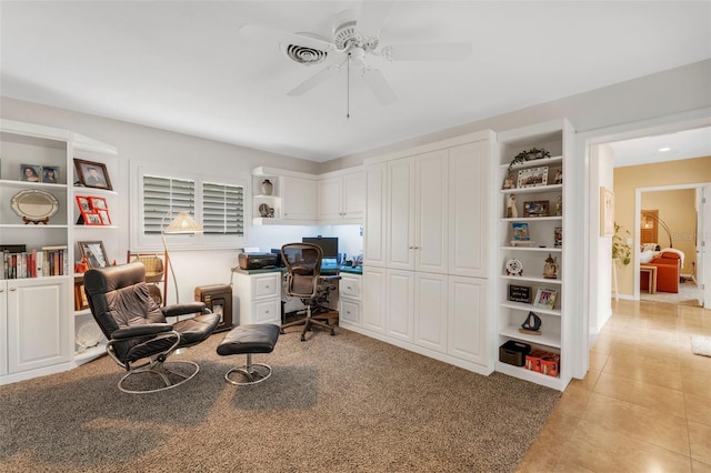 tiled office space featuring ceiling fan