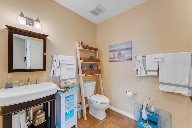 bathroom with tile patterned flooring, sink, and toilet