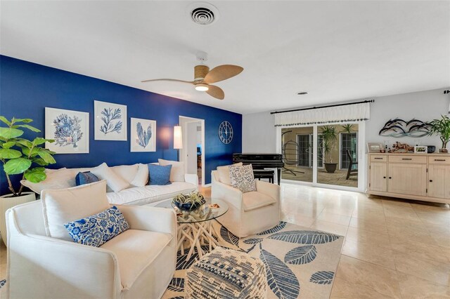 living room featuring light tile patterned flooring, visible vents, and ceiling fan