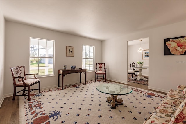 sitting room with an inviting chandelier and wood-type flooring