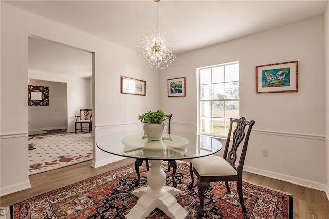 dining room with an inviting chandelier and hardwood / wood-style floors