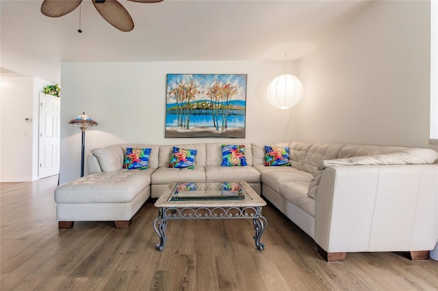 living room featuring ceiling fan and wood-type flooring