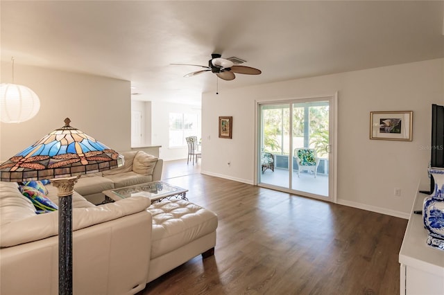 living room with ceiling fan and dark hardwood / wood-style floors