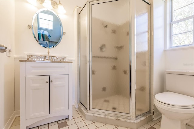 bathroom with vanity, toilet, tile patterned flooring, and walk in shower