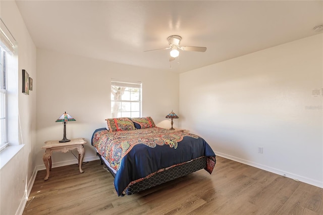 bedroom featuring ceiling fan and hardwood / wood-style flooring