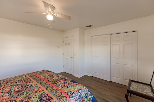 bedroom featuring ceiling fan, a closet, and dark hardwood / wood-style flooring