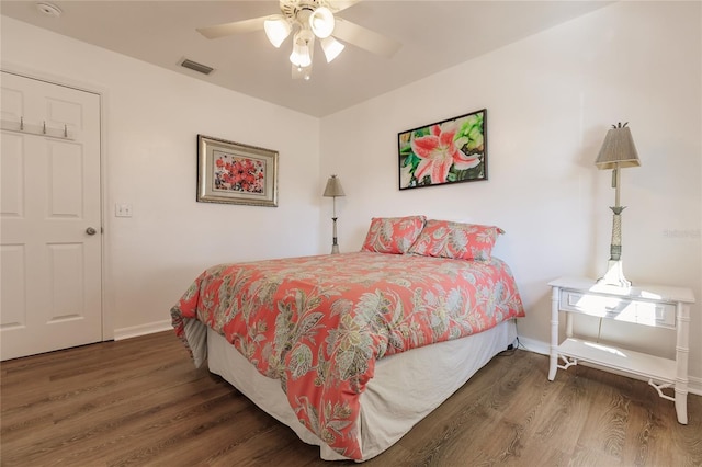 bedroom with ceiling fan and dark hardwood / wood-style flooring